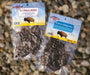 Two bags of Buffalo Jerky by Quality Markers, one labeled Buffalo Jerky and the other Buffalo Tenchum Jerky, displayed on a gravel background.