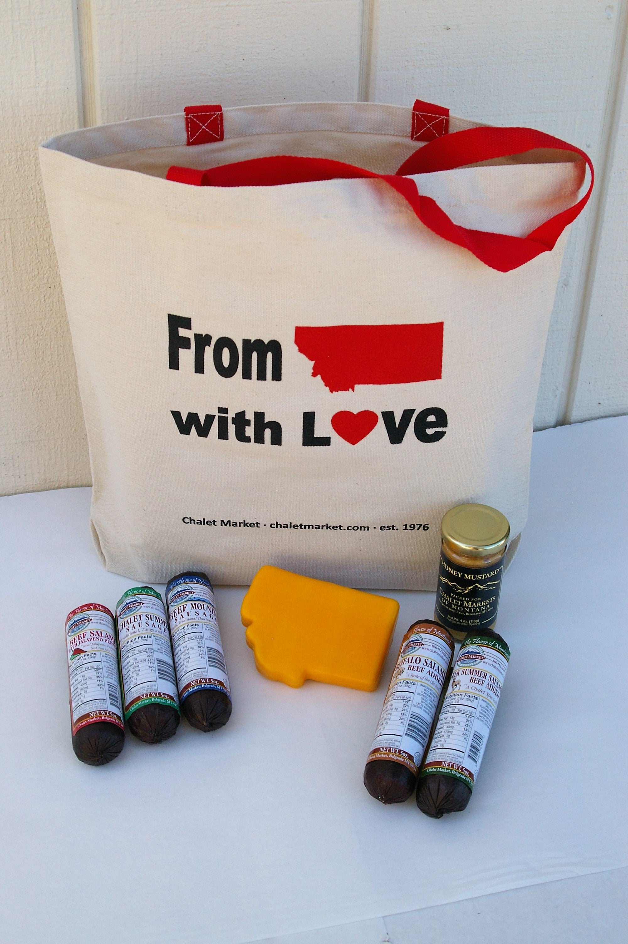 From Montana with love reusable tote bag gift #10.  5 5oz. Chalet Market sausages, MT shaped cheese and a 4 oz. honey mustard..  